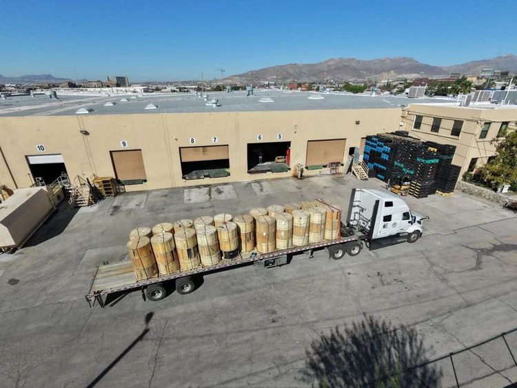 Flatbed loaded with wooden fiber optic cable reels at the DIR loading docks in El Paso