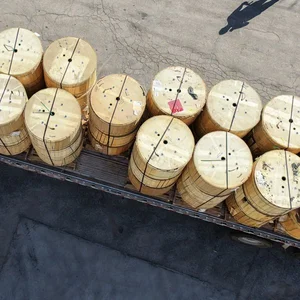 Wooden reels of fiber optic cable loaded on a flatbed