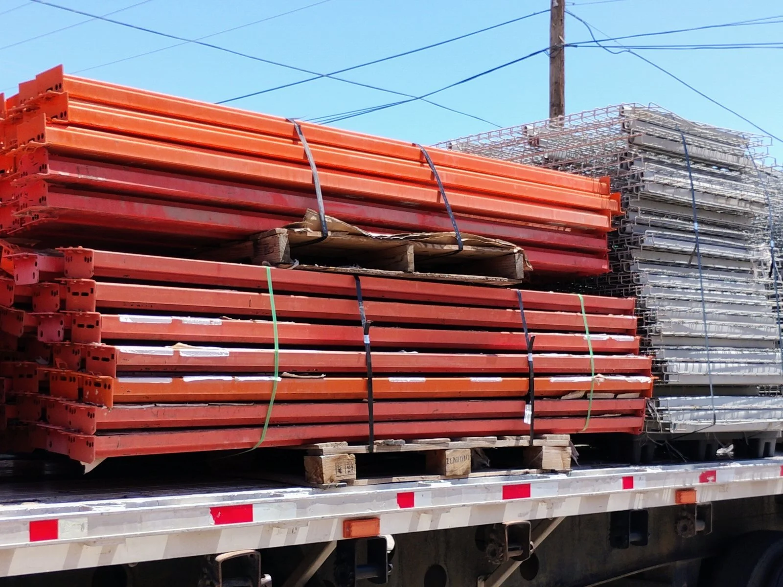 Pallet rack beams and wire decking loaded on a flatbed trailer