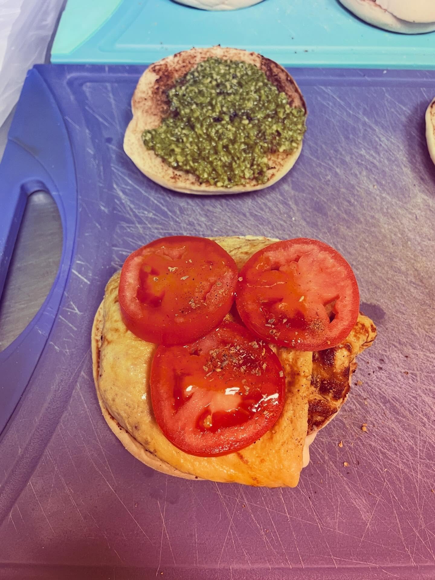 Tomato basil egg and cheese on a Portuguese muffin