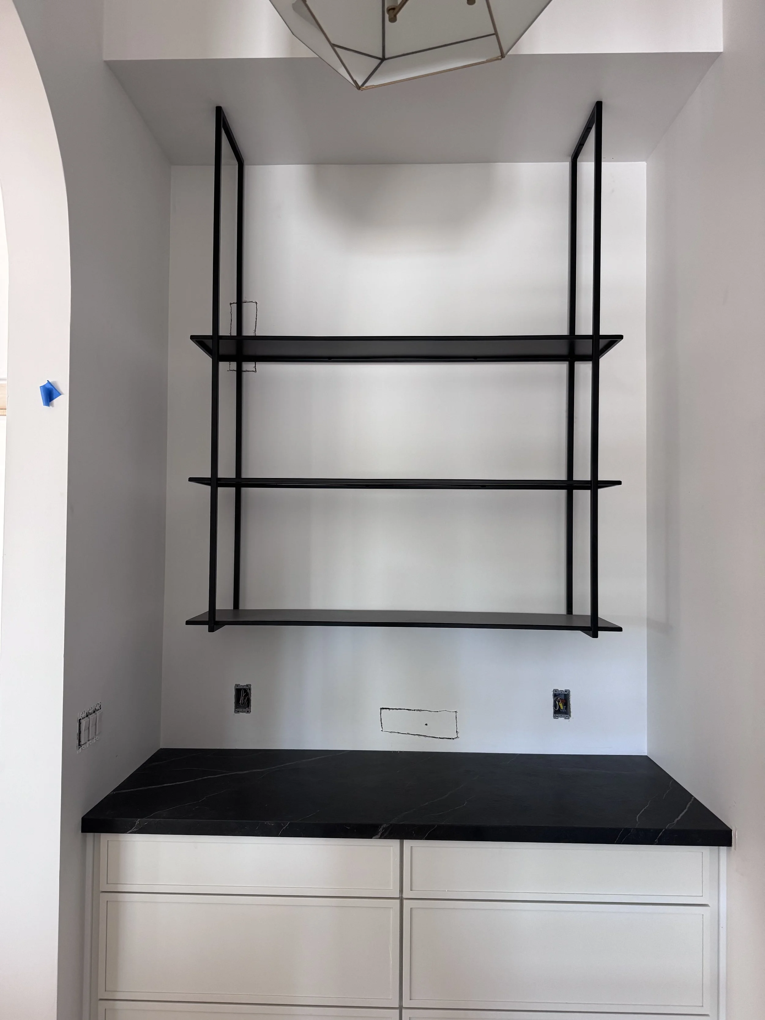 Floating blackened steel shelving