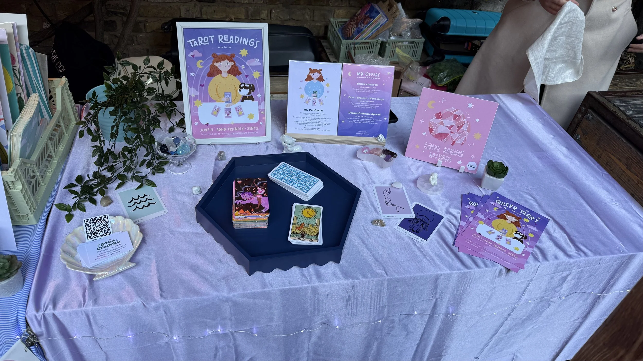Gosia and her tarot reading table at an outdoor event.