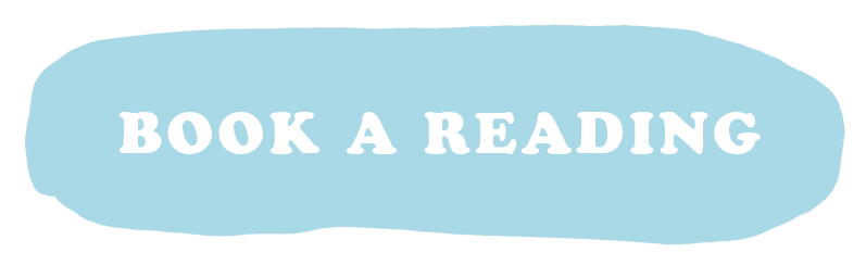 Light blue oval sign with white text that says 'BOOK A READING'.
