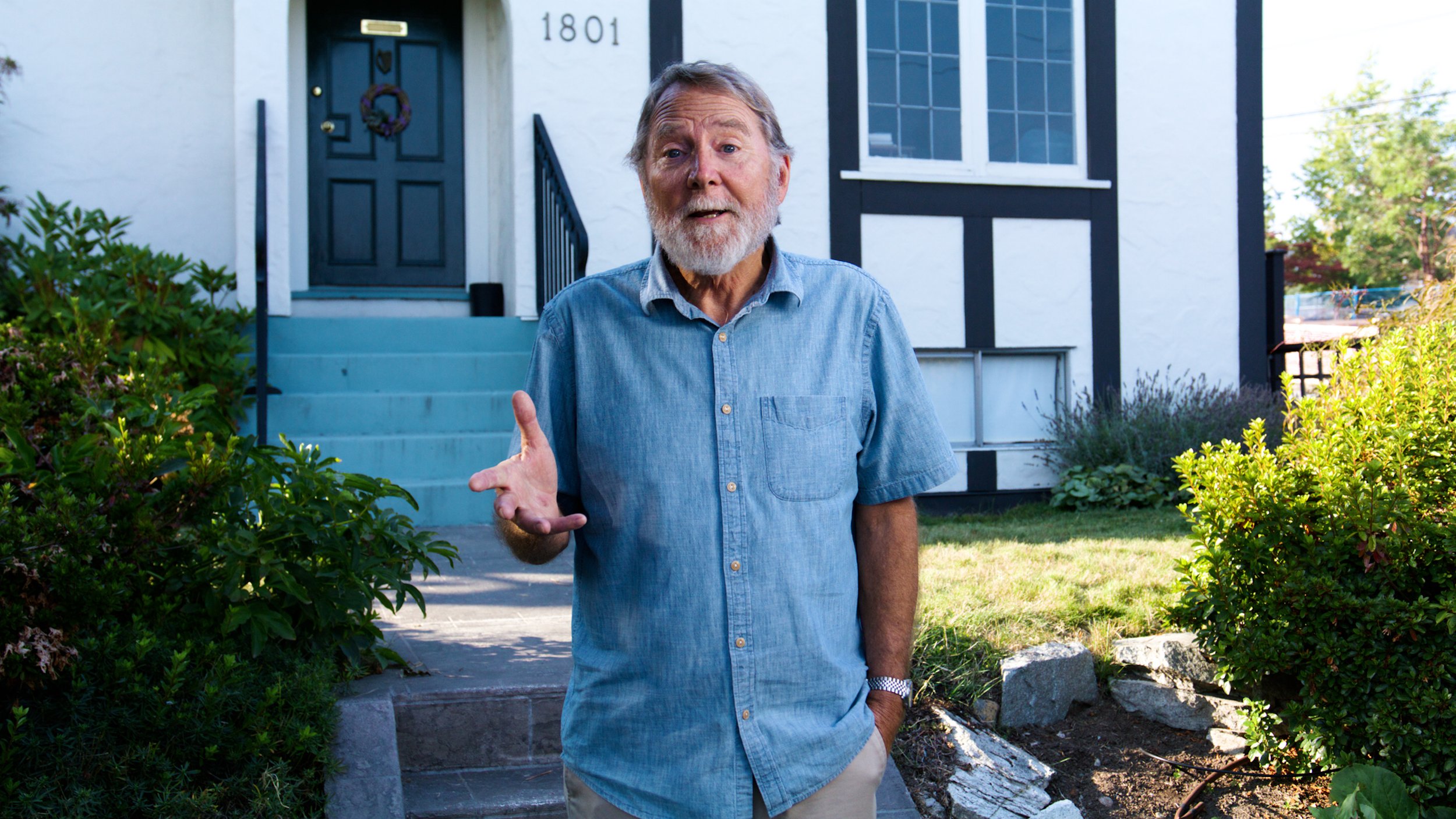 Homeowner speaking outside his house during a filmed interview.
