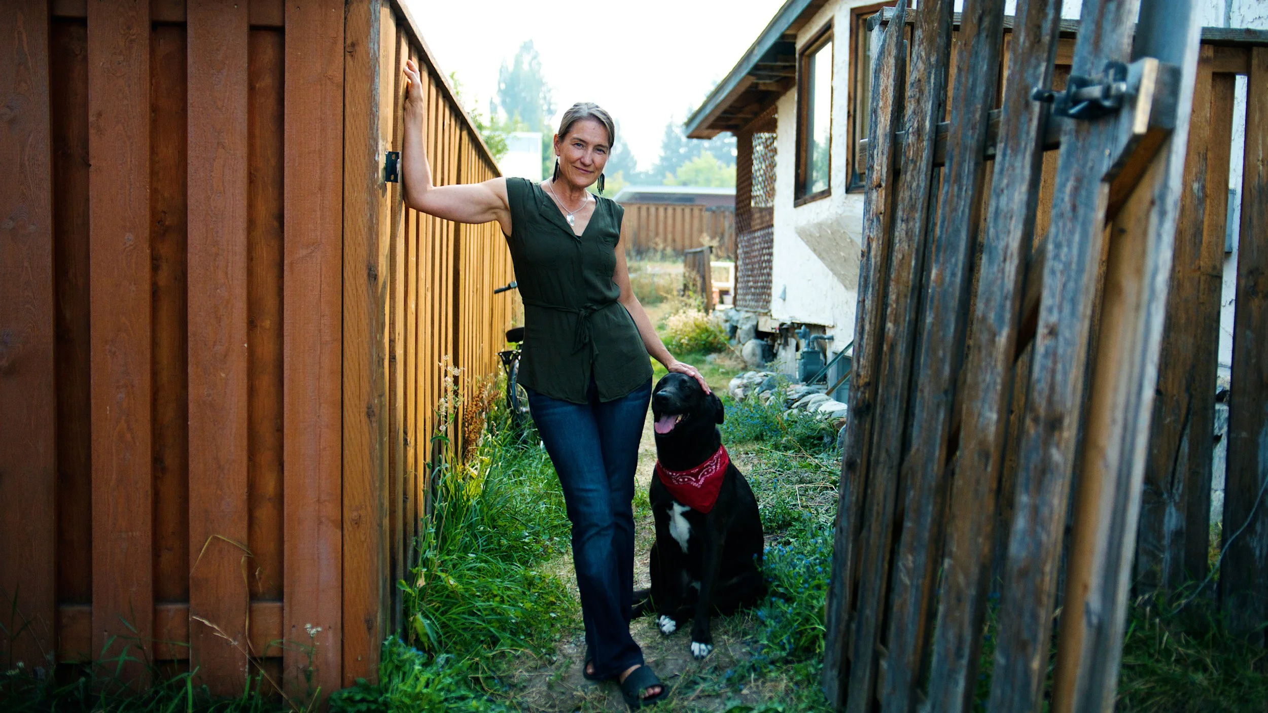 Homeowner standing outside her home with her dog during a filmed interview for FortisBC.