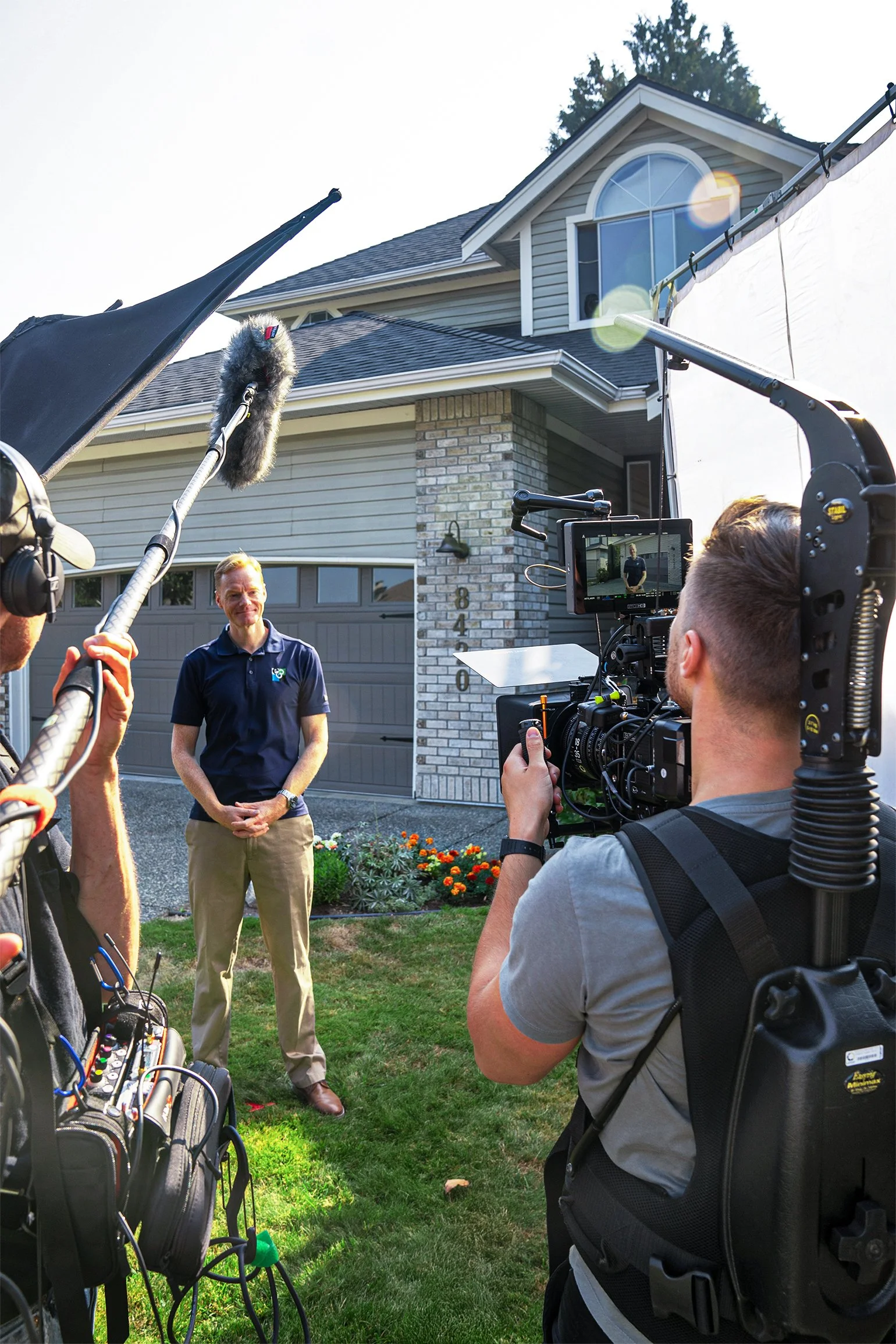 Filming an outdoor interview for FortisBC with a boom operator and cinema camera setup.