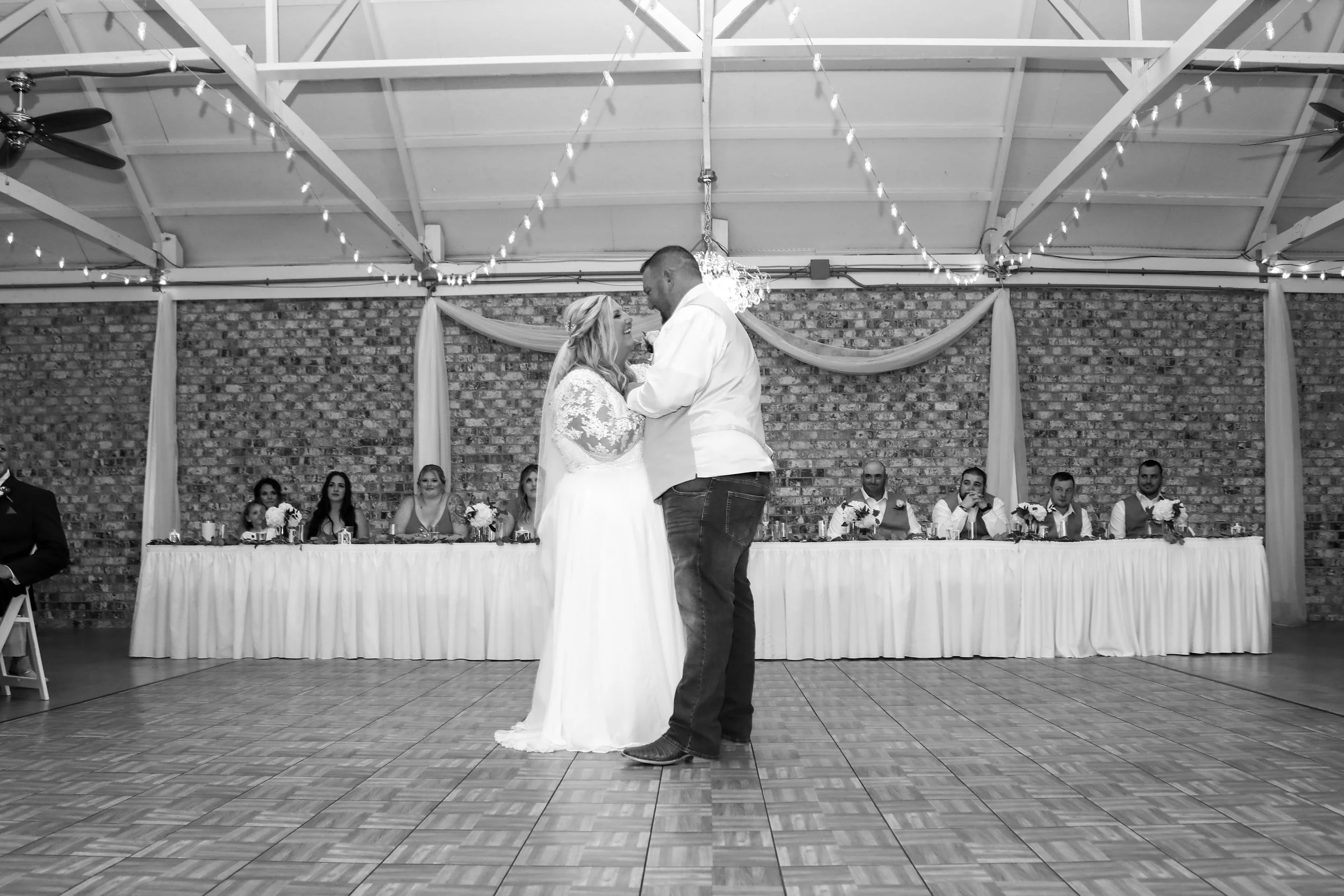 This is a scenic boho rustic view of the inside of The Magnolia Barn award-winning reception hall outdoor barn wedding venue featuring an exposed brick wall with natural light in Miamisburg at Magnolia Estate. Surrounded by the Greater Dayton, Columb