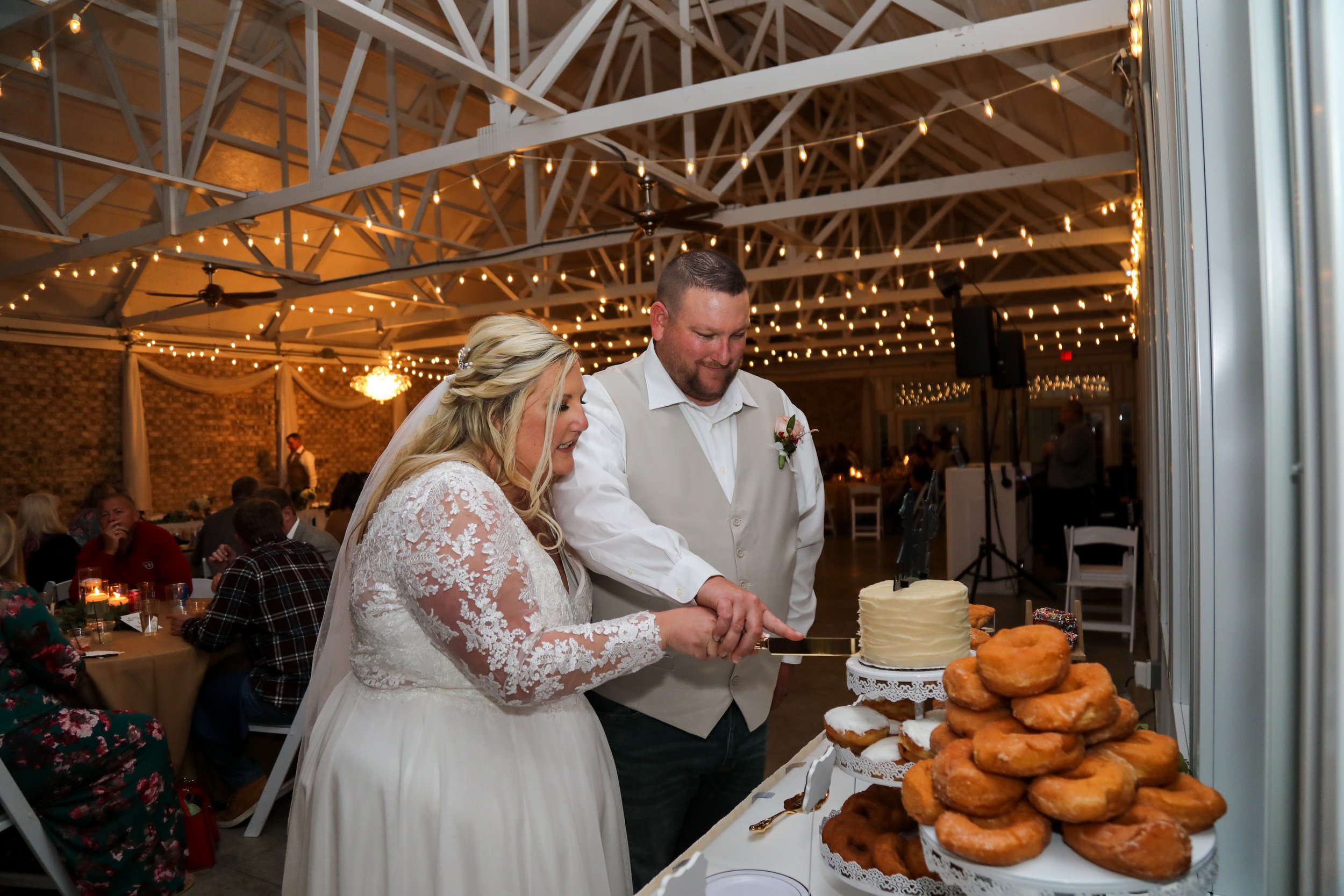 This is a scenic boho rustic view of the inside of The Magnolia Barn award-winning reception hall outdoor barn wedding venue featuring an exposed brick wall with natural light in Miamisburg at Magnolia Estate. Surrounded by the Greater Dayton, Columb
