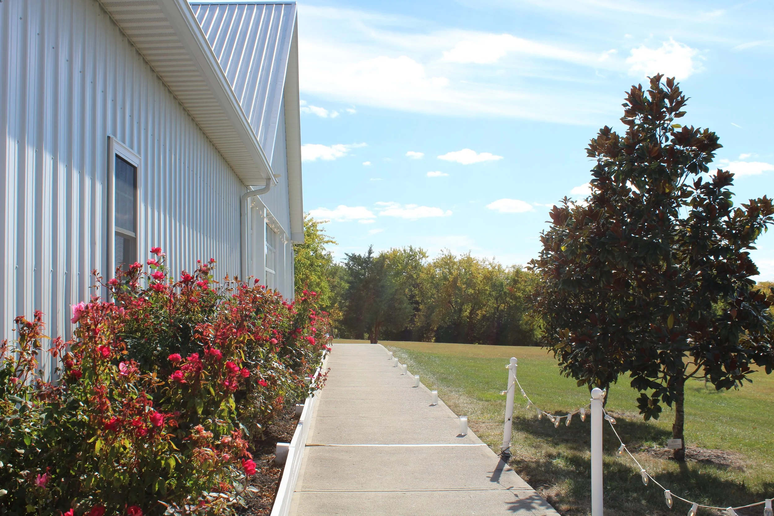 This is a scenic boho rustic view of the west side of The Magnolia Barn award-winning reception hall outdoor barn wedding venue in Miamisburg at Magnolia Estate. Surrounded by the Greater Dayton, Columbus, and Cincinnati areas. 