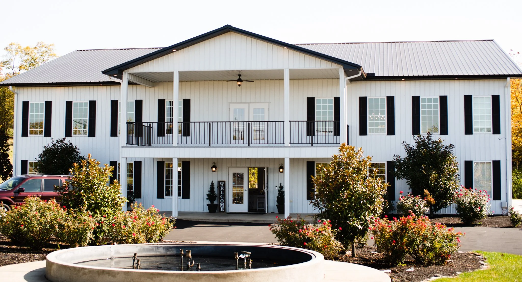 This is a scenic boho elegant rustic view of the front of the award-winning reception hall outdoor mansion wedding venue Rosewood Manor in Miamisburg at Magnolia Estate. Surrounded by the Greater Dayton, Columbus, and Cincinnati areas. 