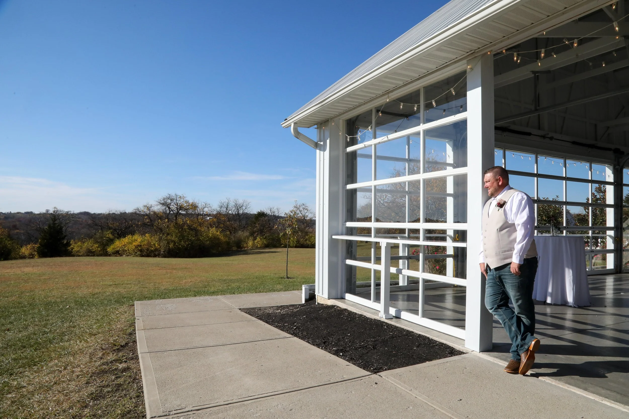 This is a scenic boho rustic view of the inside of The Magnolia Barn award-winning reception hall outdoor barn wedding venue featuring an exposed brick wall with natural light in Miamisburg at Magnolia Estate. Surrounded by the Greater Dayton, Columb