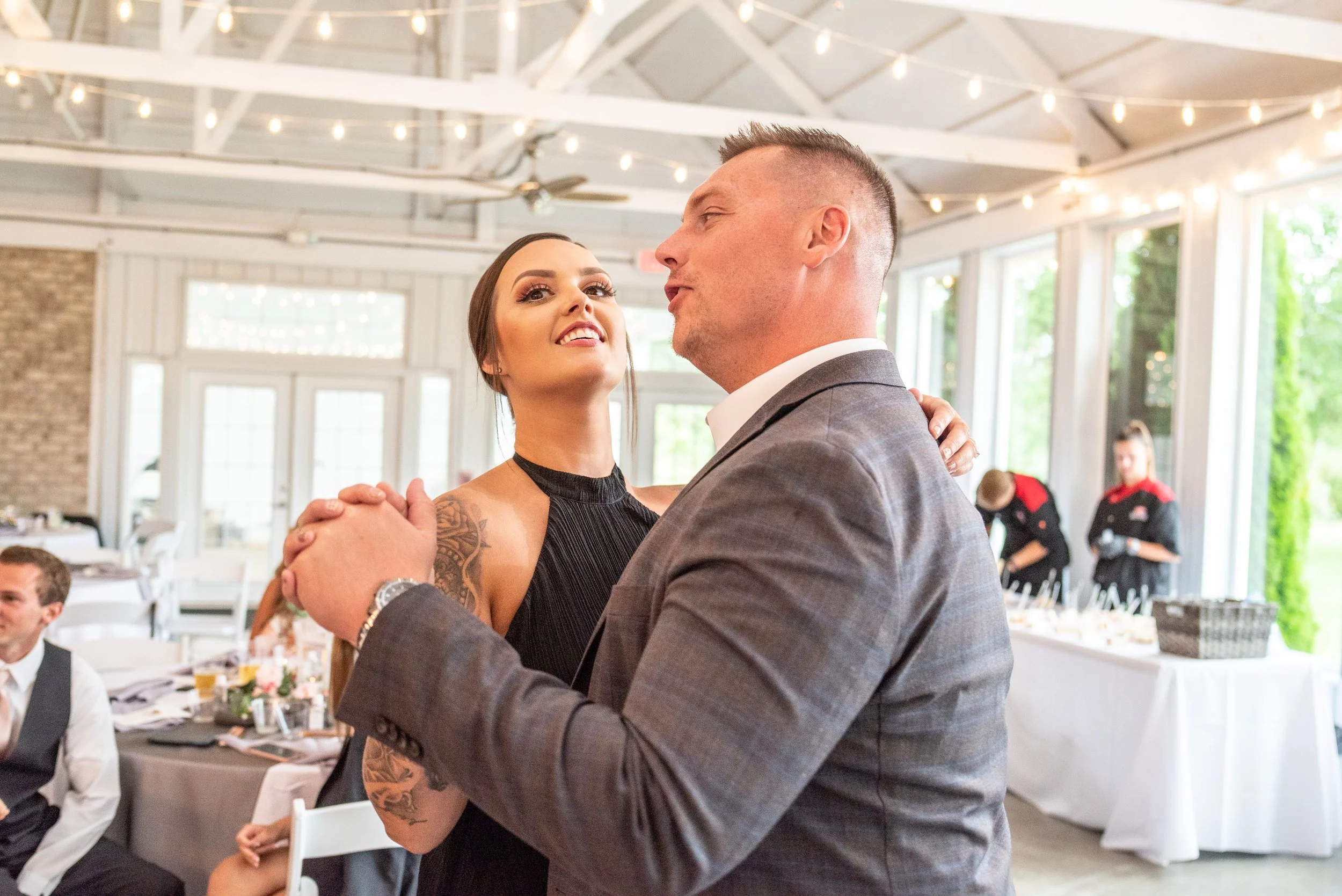 This is a scenic boho rustic view of the inside of The Magnolia Barn award-winning reception hall outdoor barn wedding venue featuring an exposed brick wall with natural light in Miamisburg at Magnolia Estate. Surrounded by the Greater Dayton, Columb