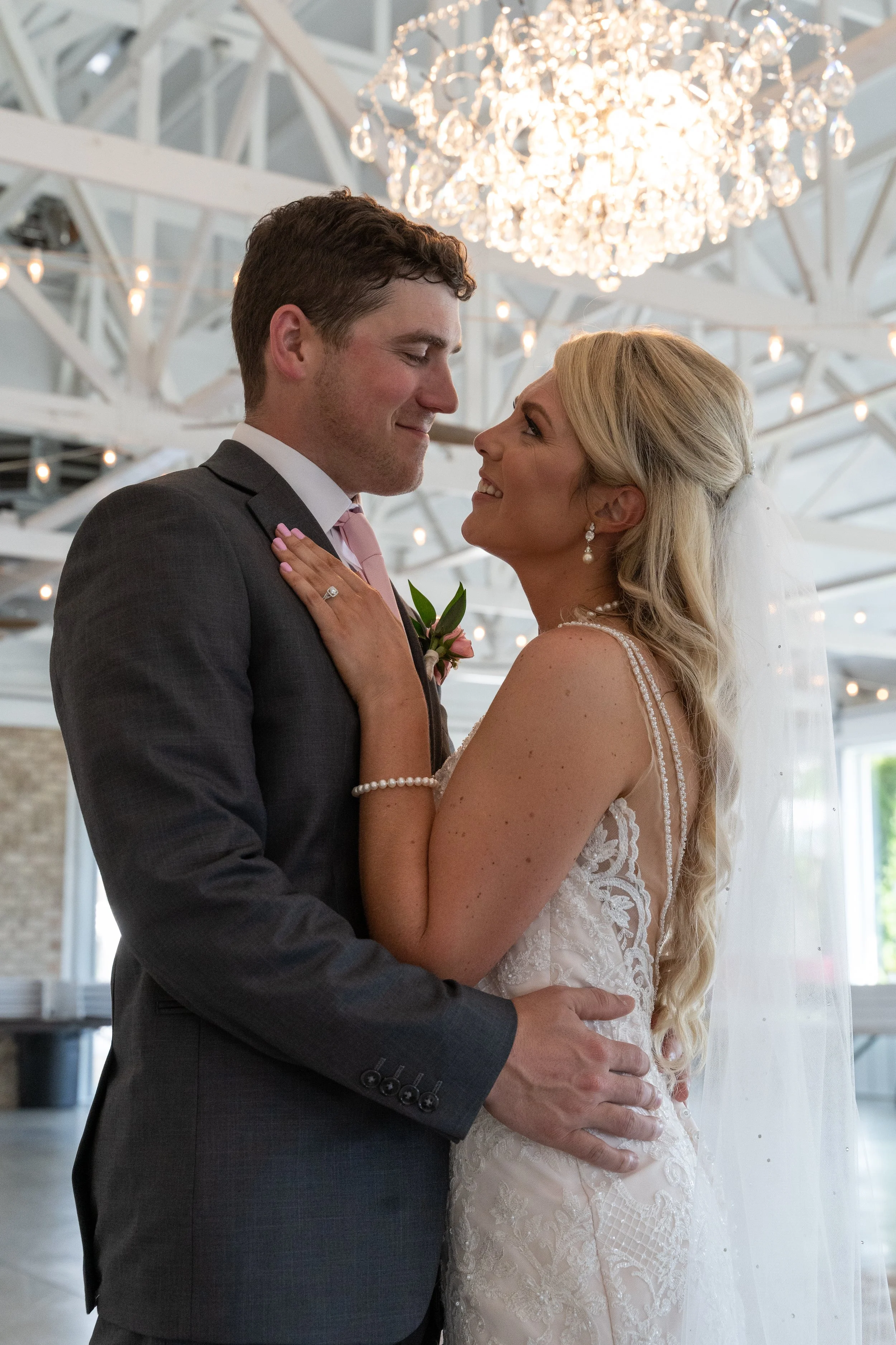 This is a scenic boho rustic view of the inside of The Magnolia Barn award-winning reception hall outdoor barn wedding venue featuring an exposed brick wall with natural light in Miamisburg at Magnolia Estate. Surrounded by the Greater Dayton, Columb