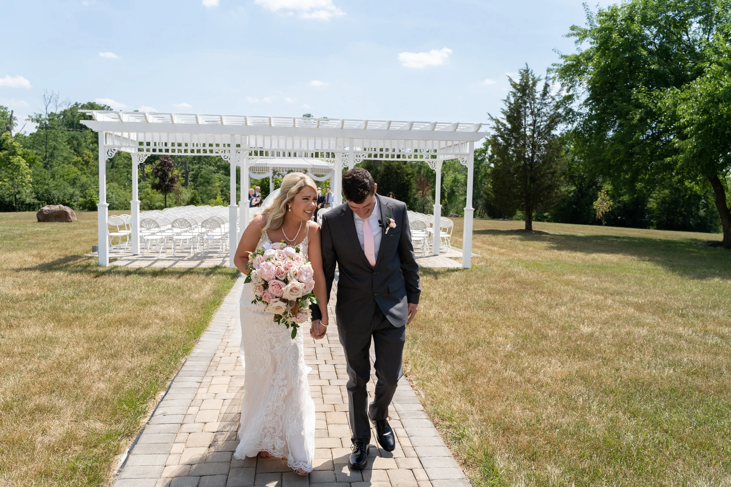 This is a scenic boho rustic view of the outdoor ceremony area of The Magnolia Barn award-winning reception hall outdoor barn wedding venue in Miamisburg at Magnolia Estate. Surrounded by the Greater Dayton, Columbus, and Cincinnati areas. 