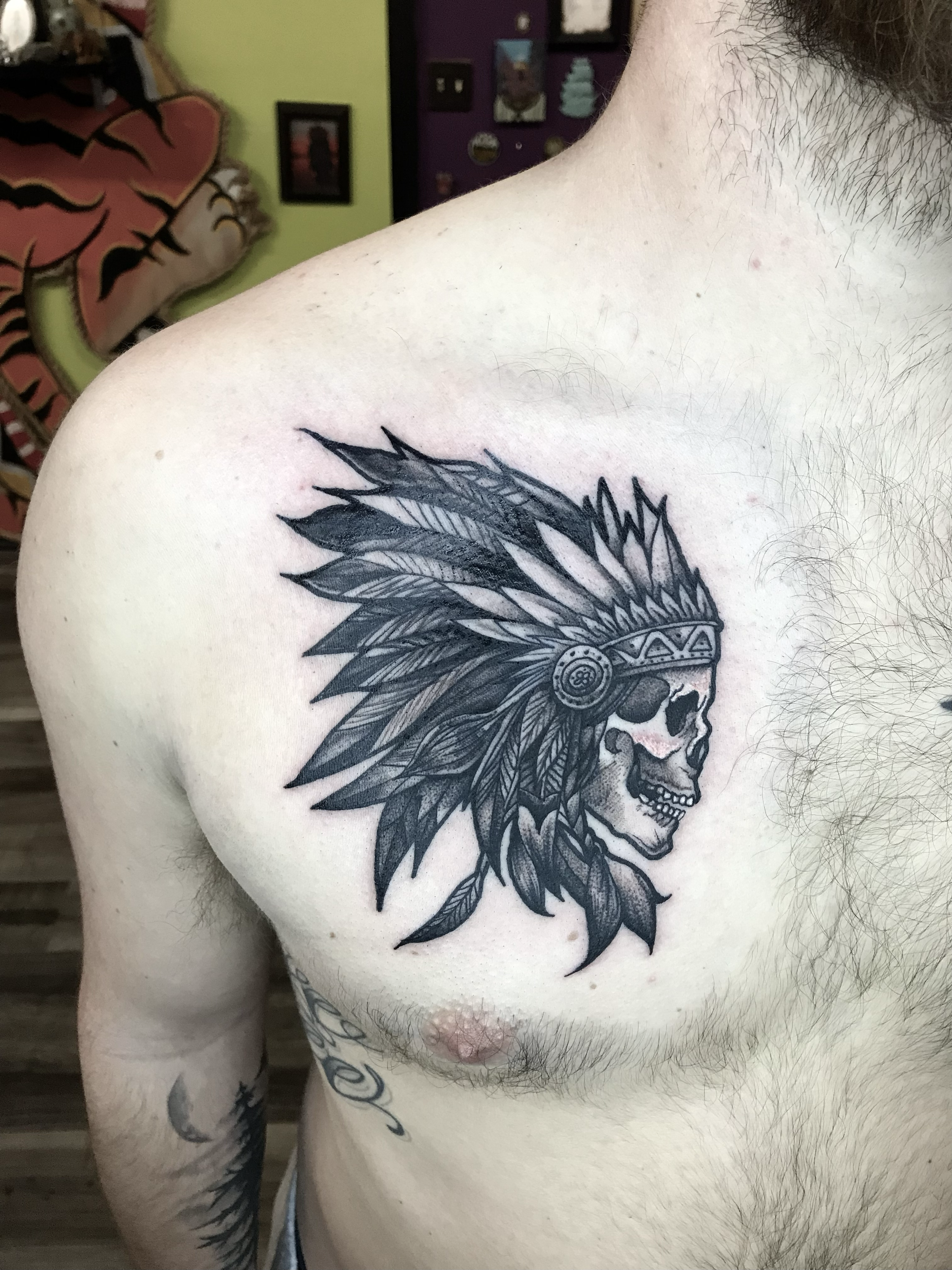 black and grey Native American skull head design on chest 