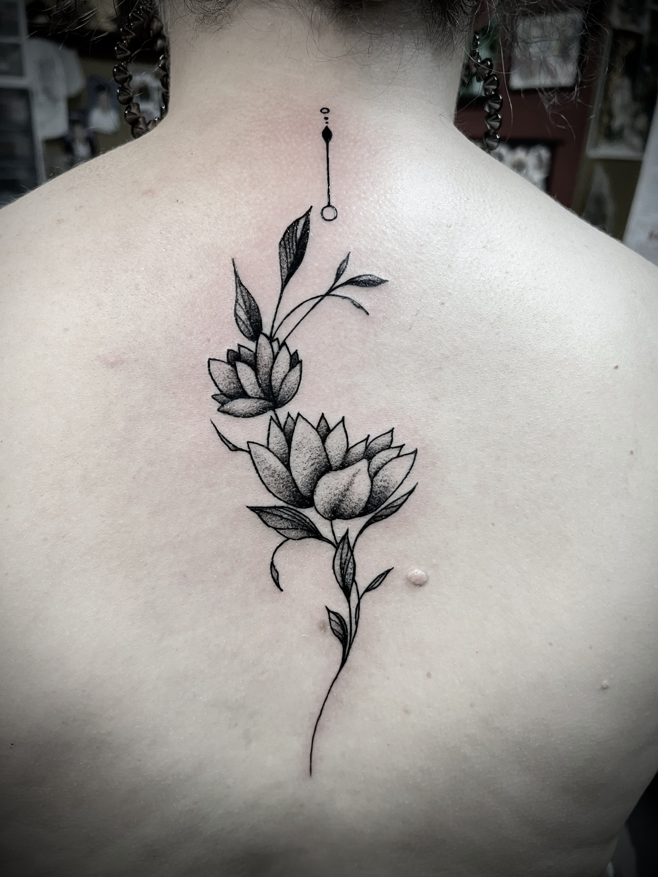 This is a fine line flower tattoo done on the spine , it was her first tattoo and did well dealing with the tattoo discomfort 
