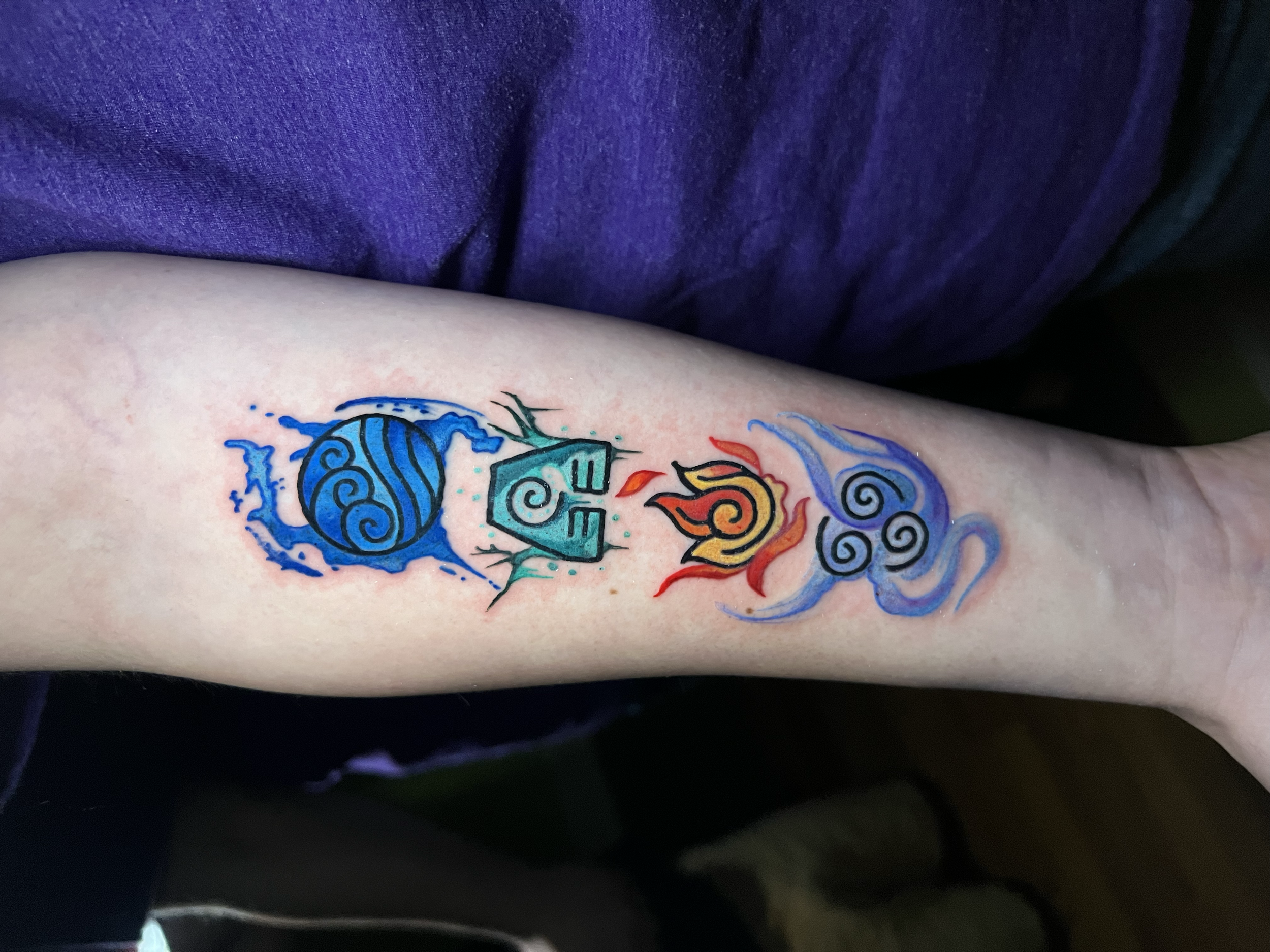 Avatar: The Last Airbender inspired color tattoo featuring water, ears, fire, and air elemental symbols with bold linework by Salvador Vargas III, serving bluffton sc, savannah ga , and Charleston sc 