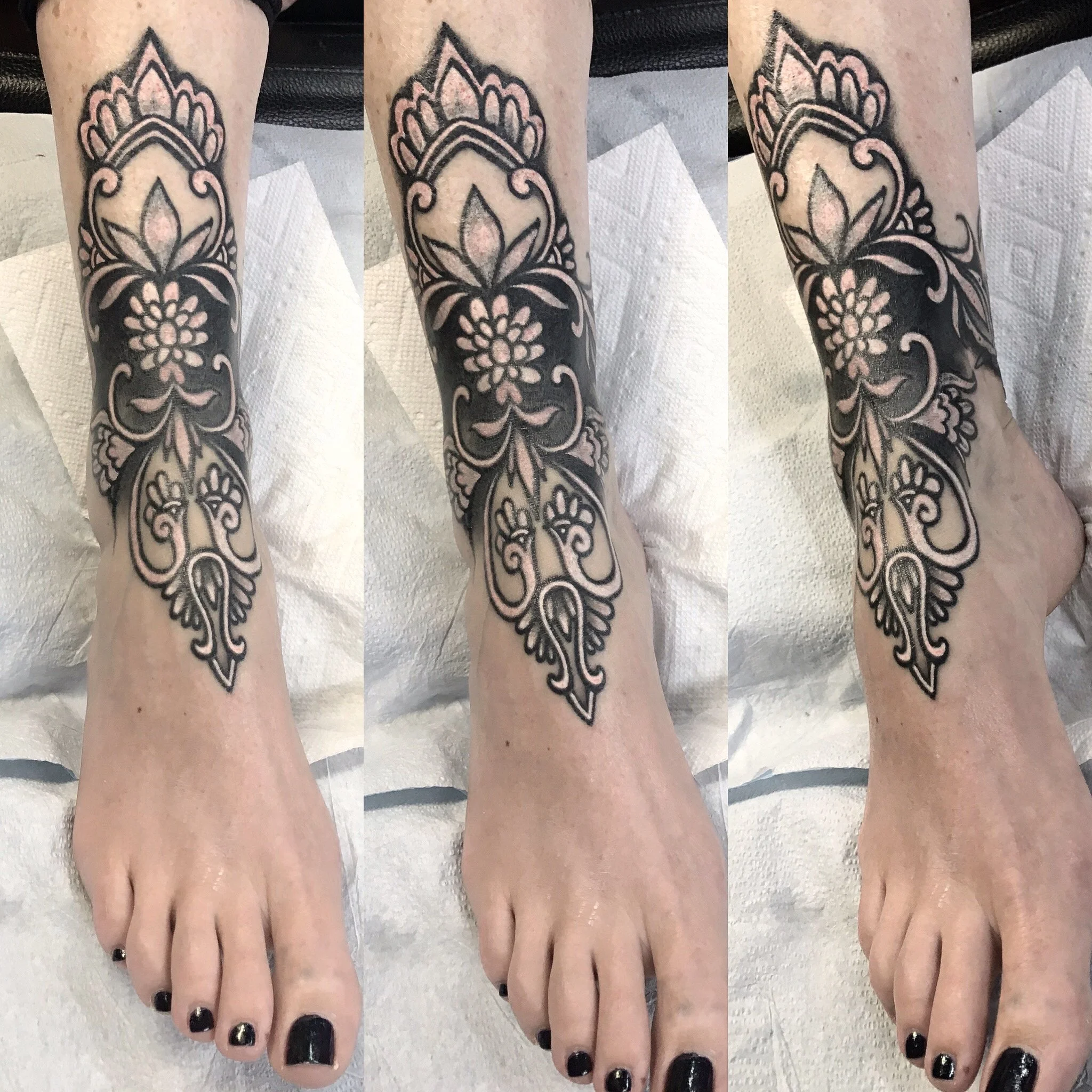 Tattoo sleeve on person's forearm with floral and ornamental design in black ink, extending from wrist to elbow.