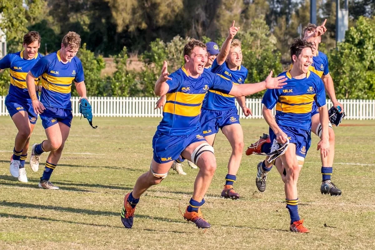 Toowoomba Grammar School rugby players celebrating on the sports field.