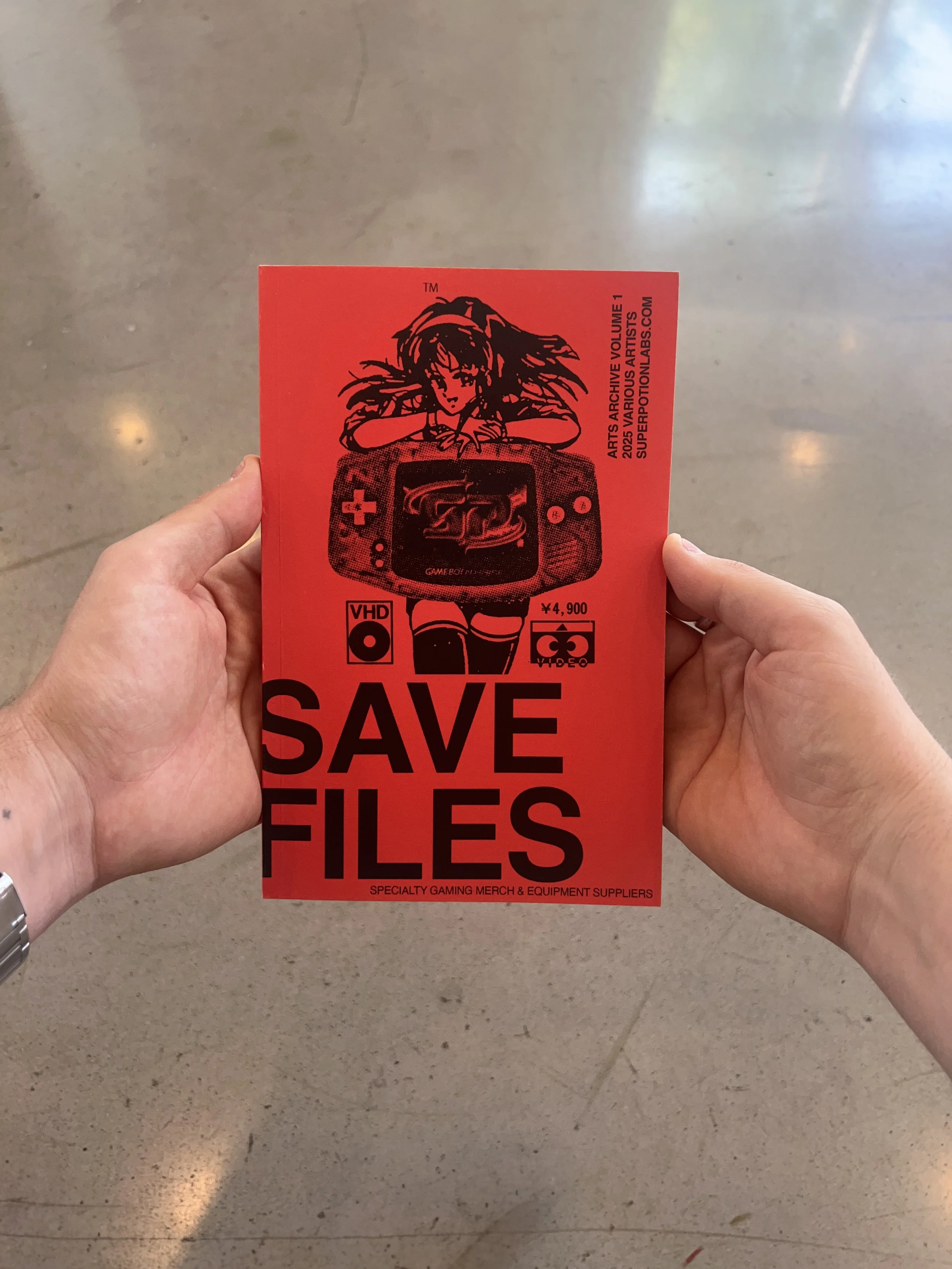 Red promotional flyer with black illustration of a girl with long hair and a gaming console, text that says 'Save Files', and additional small icons and text about gaming merchandise and equipment.