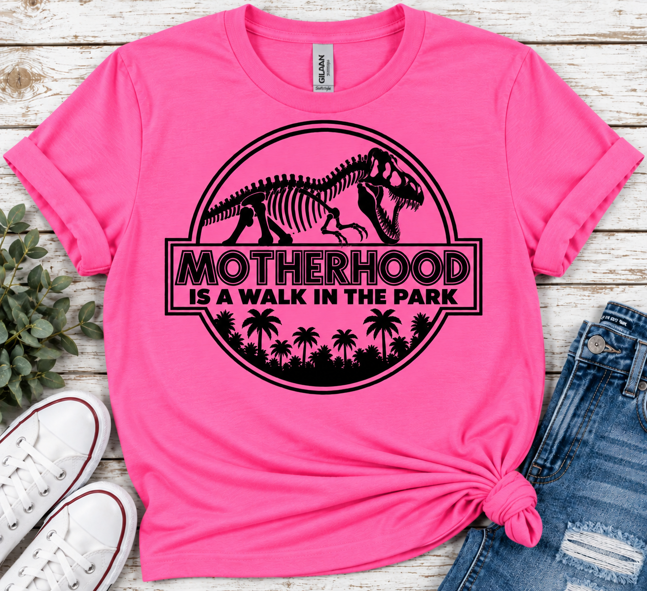 Motherhood Is a Walk in the Park Women’s T-Shirt – Funny Dinosaur Mom Graphic Tee