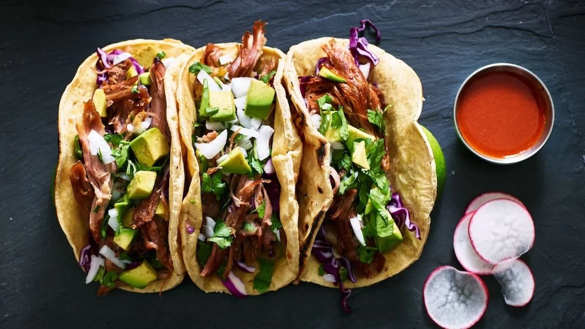 Wonderful Wednesday Blog Hop Favorites (3 tacos with red sauce & sliced radishes on black background)