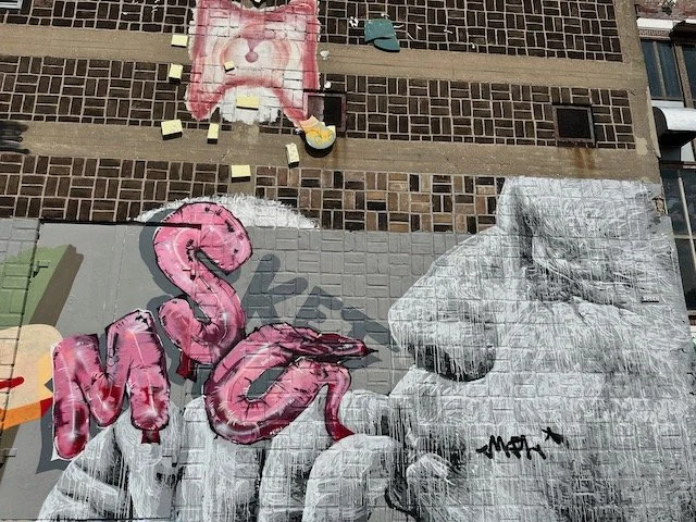 NDSM graffiti - man blowing letters.jpeg