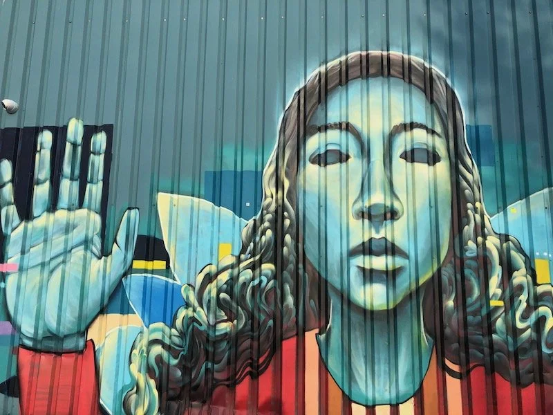 NDSM graffiti - girl with hand raised.jpeg