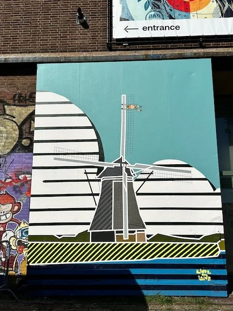 NDSM graffiti - man holding to mill.jpeg