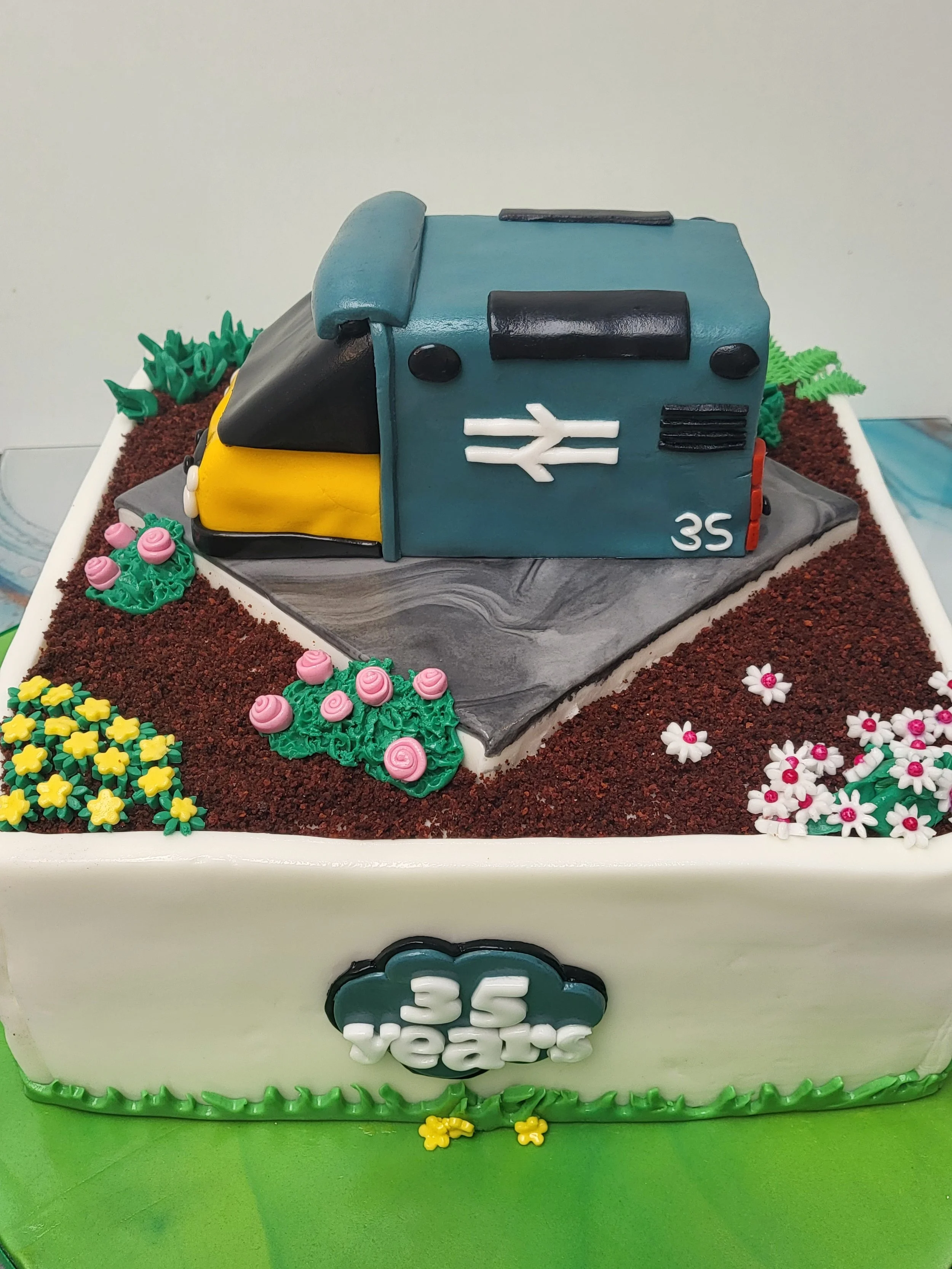 Retirment celebration cake, trains and flowers