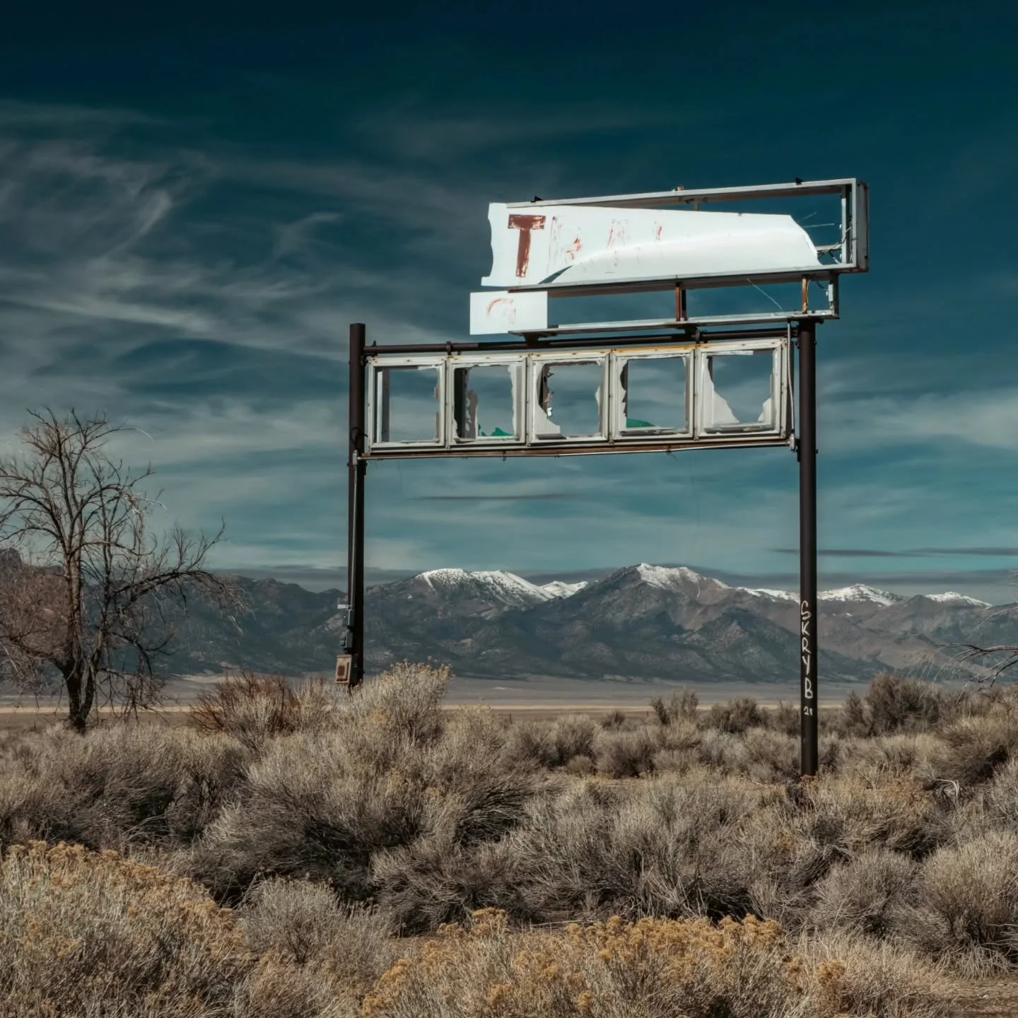 At the abandoned Slots Motel, the remains of its sign frame the Ruby Mountains 

What's left of the small motel, casino, RV park, and gas station in Schellbourne, Nevada sit in a remote area that was once an important mail station for the Pony Expres