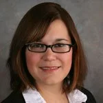 Professional woman with glasses and brown hair
