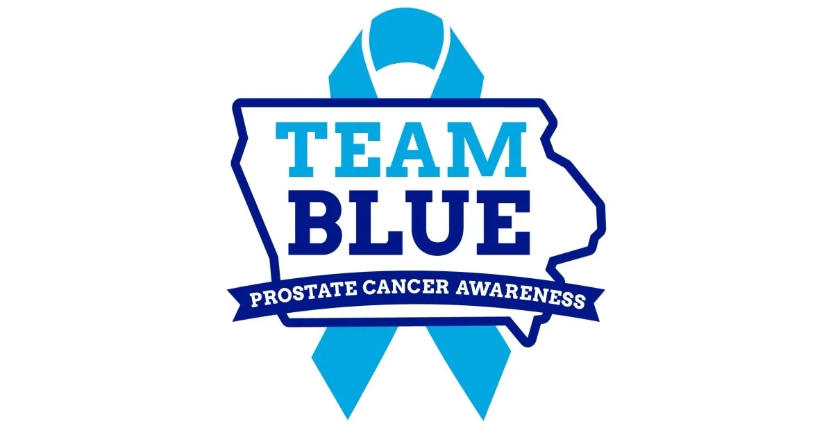 Blue ribbon shaped like a map outline with "Team Blue" and "Prostate Cancer Awareness" text.