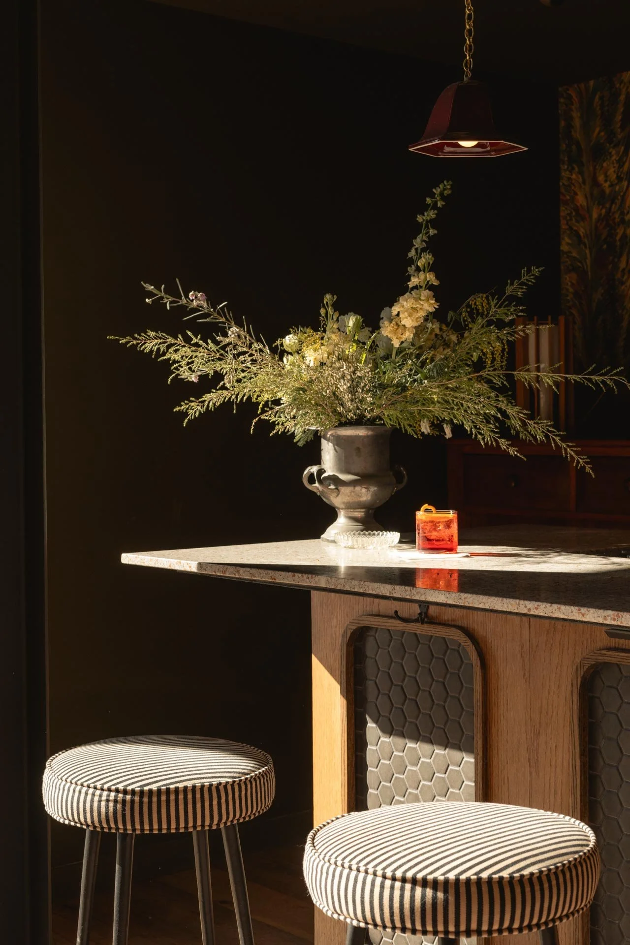 Event space for weddings and partys at hotel lilien in tannersville New York. Catskills hotel event space with a cocktail placed on bar in the sunlight. Vintage imagery and design.