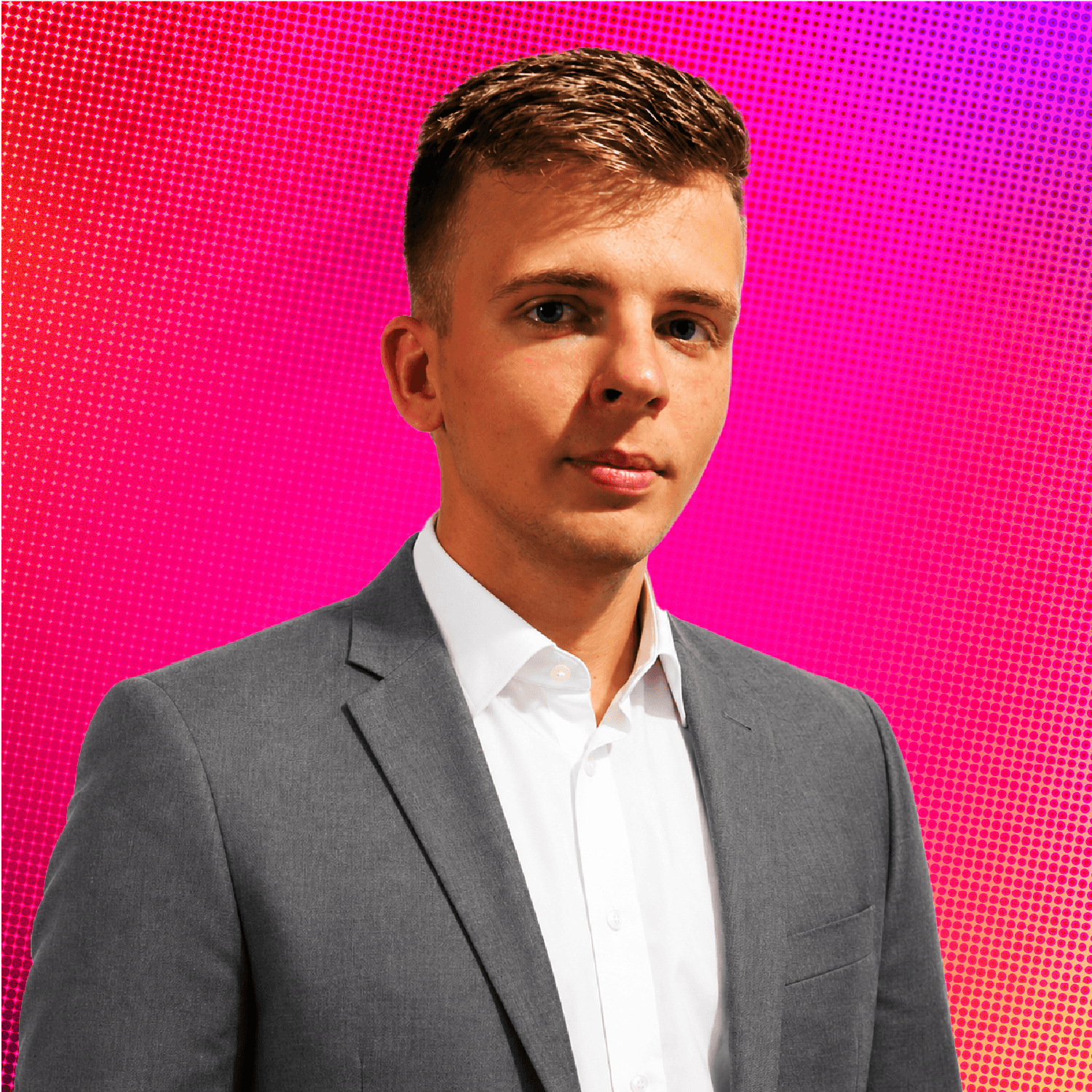 A young man with short brown hair holding a mug with a plant pattern in front of a colorful background with abstract shapes and patterns.
