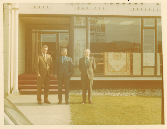 Sidhoo Fam_Ajaib standing outside EIC store.png