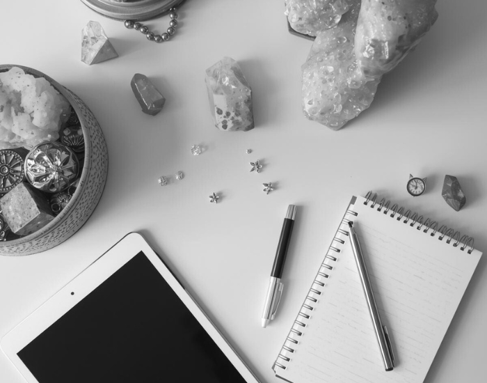 Planning workspace with journal and crystals representing the Spiritual CEO framework for building a soulful online business.
