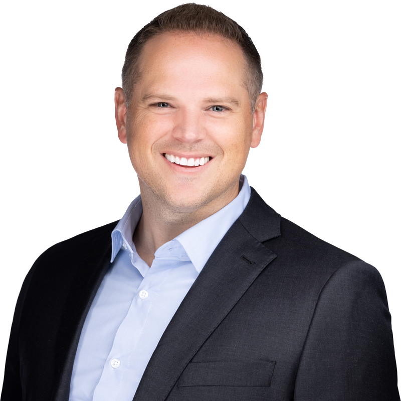 Headshot of Kevin wearing a suit on a transparent background