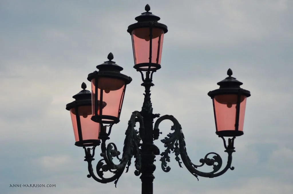 The famouse pink lamps of Venice, seen against a pale blue sky