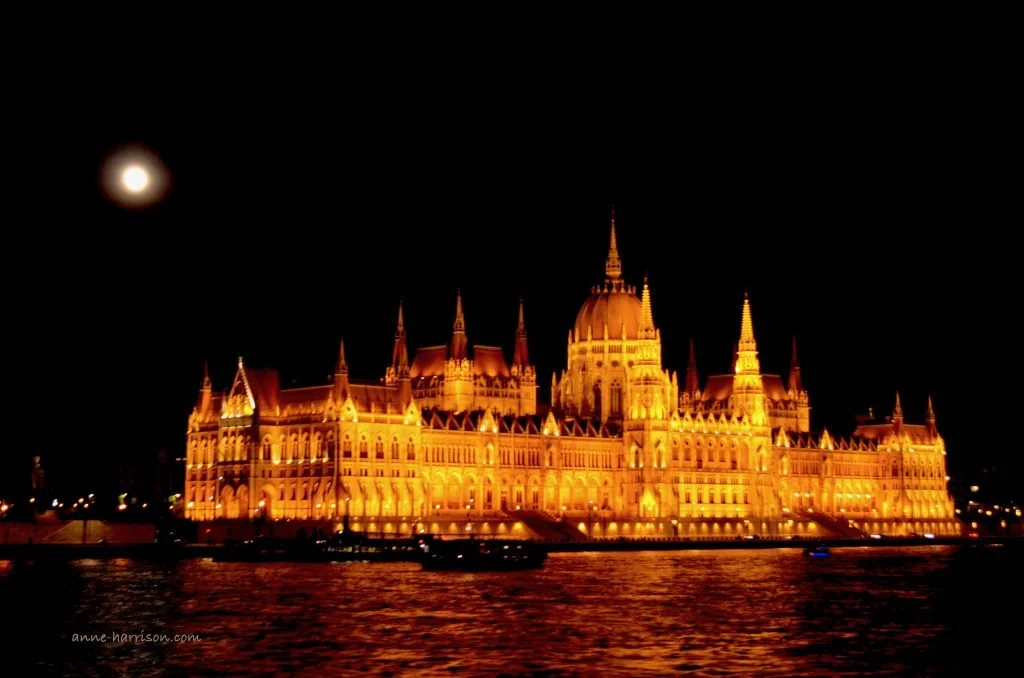 The Houses of Parliament n Budapest seen at night, under a full moon