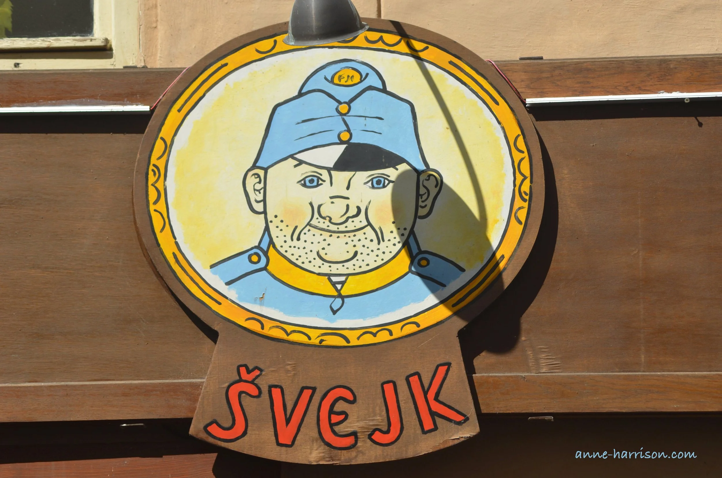 A painting of the Good Soldier Svejk above the entrance to a pub