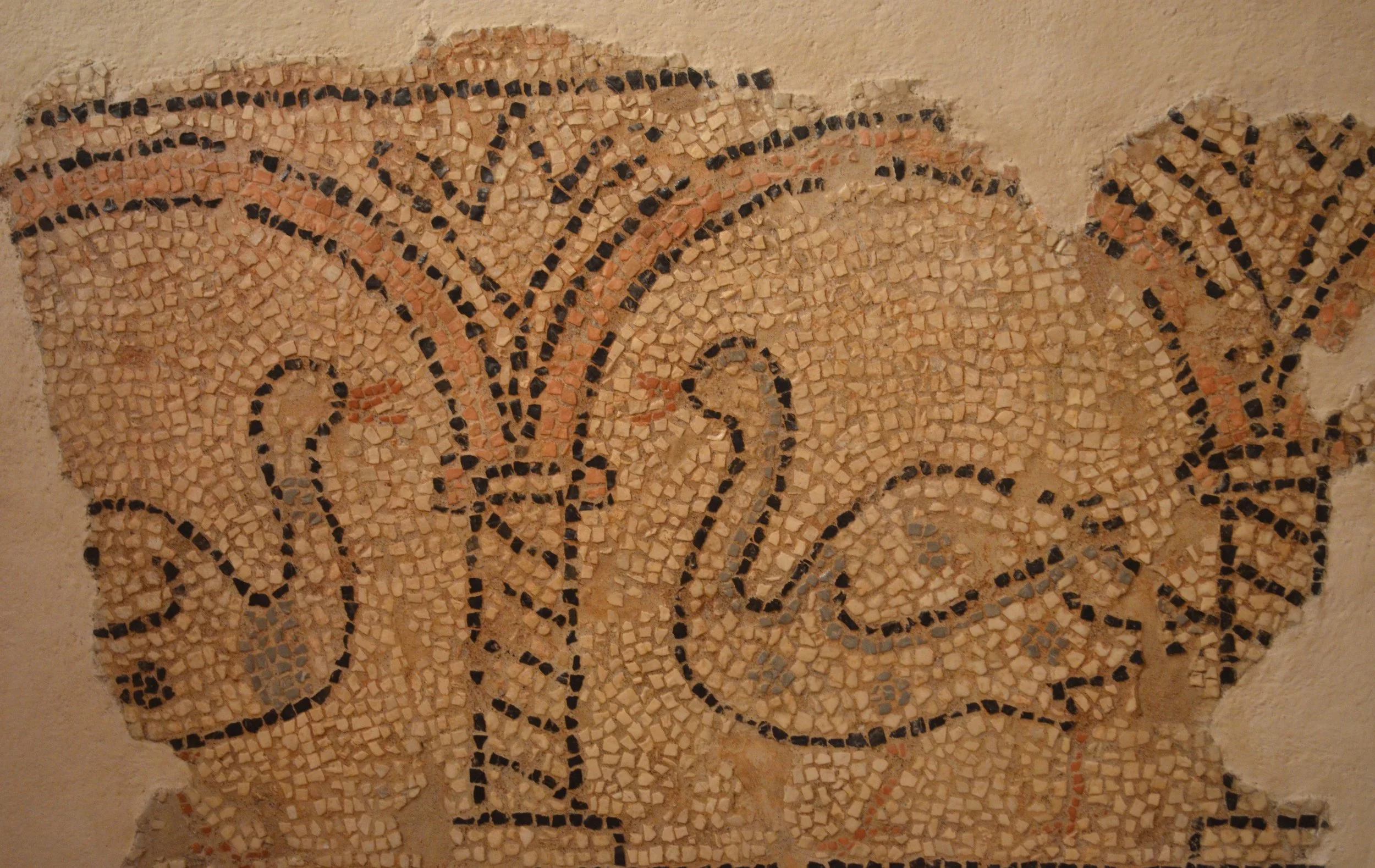 Remnants of a mosaic in St Spyridon, Corfu, showing two ducks. They are facing each other as they stand underneath arches.