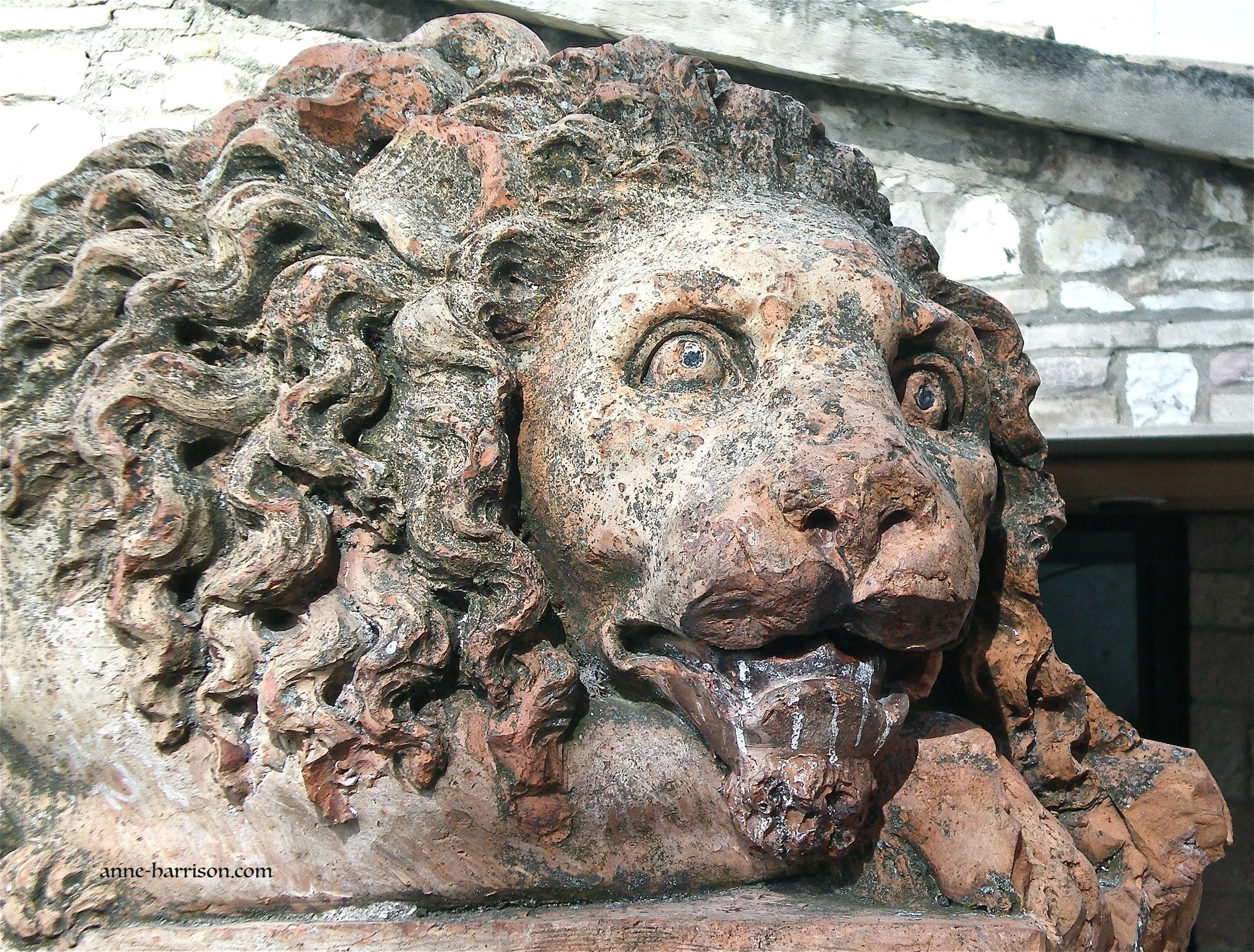 Details of the the head of an old stone lion