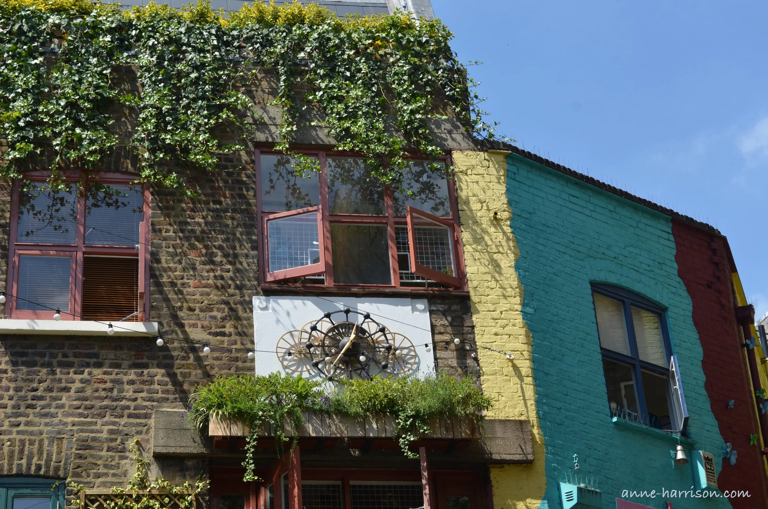 The colourful painted stone walls of Neal Street and Seven Dials in London.