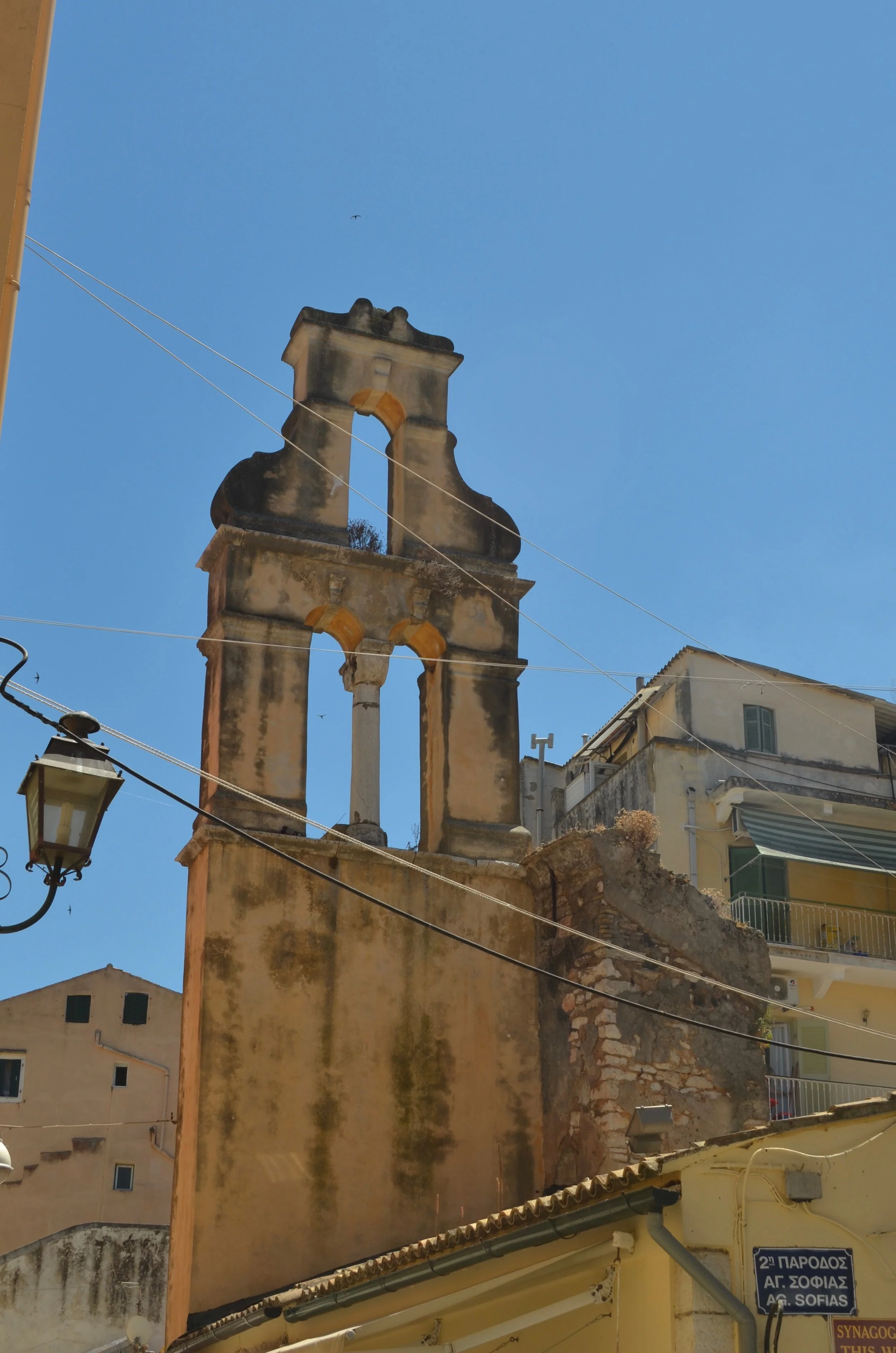  A ruined church tower in Corfu. The blue sky is visible through the arches. 