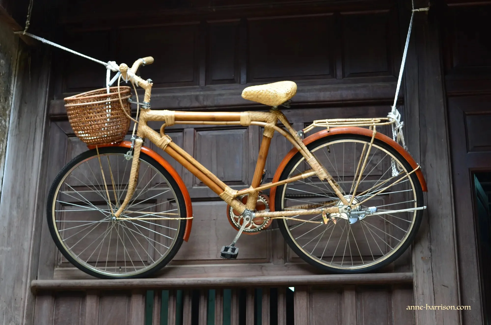 an old bike with bamboo seat and basket used as a shop front decoration in Hoi An.