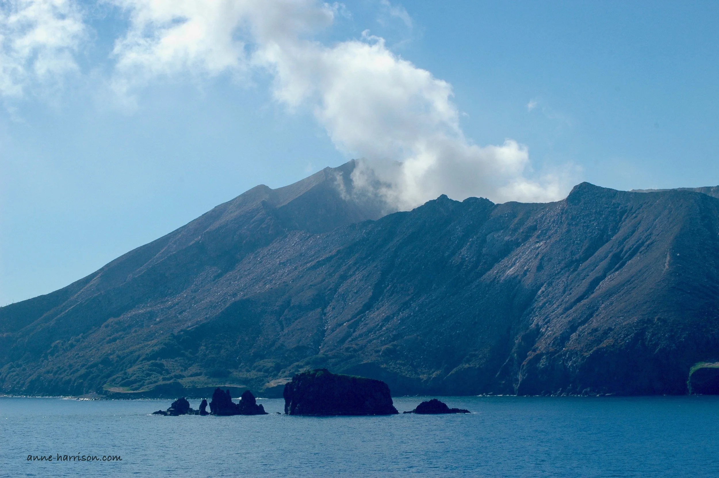 A Volcano, A Dinosaur and Clouds.
