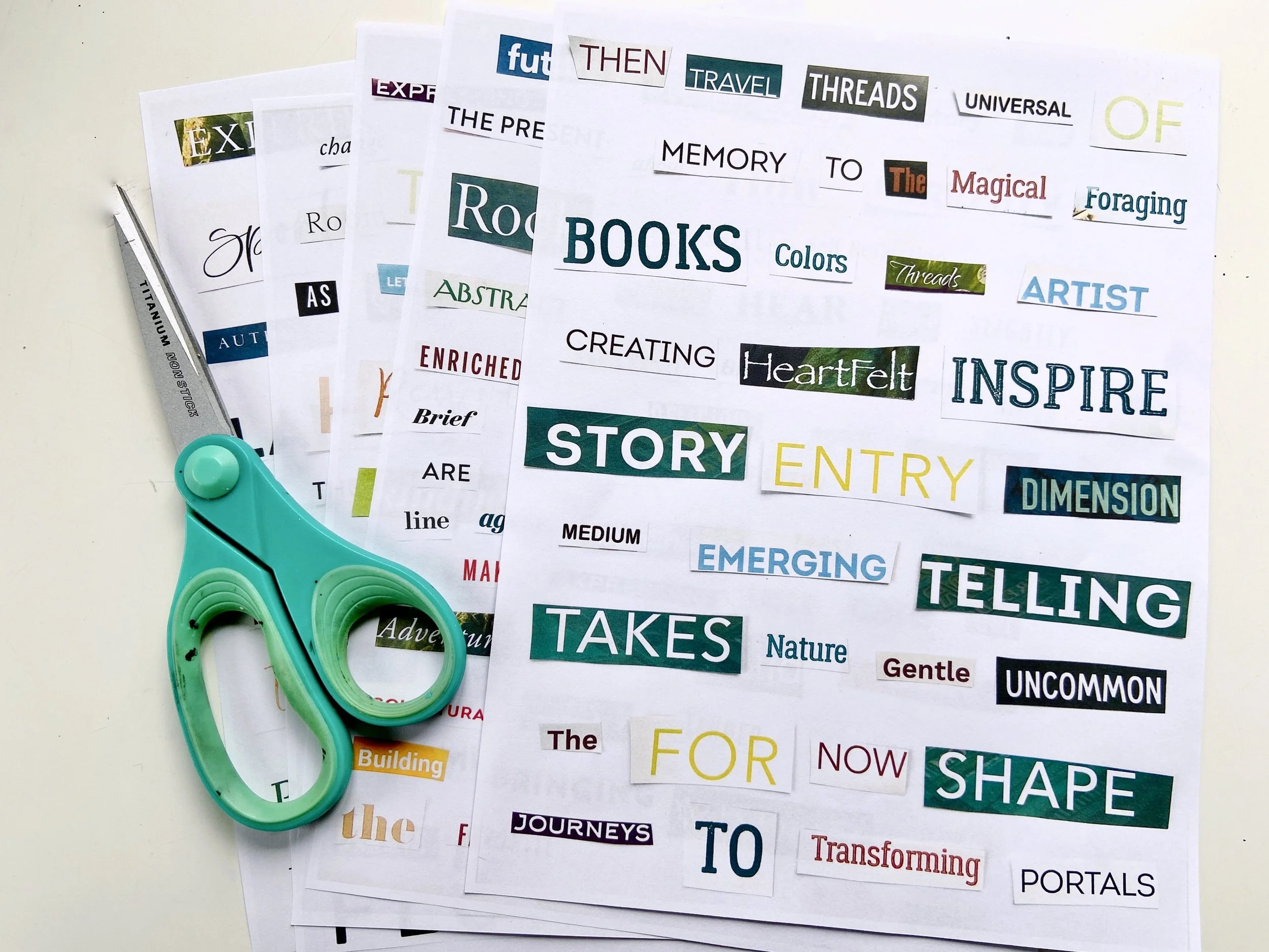 A collage of words cut from magazines on paper. An open book with the words "Tune in to the poem dimension" is on the left with cut out words around it. Scissors and other word cutouts, including "Garden," are visible. On the right are various unrelated words pasted on paper, such as "Books," "Colors," "Story," and "Telling." An orange candle is also in view.