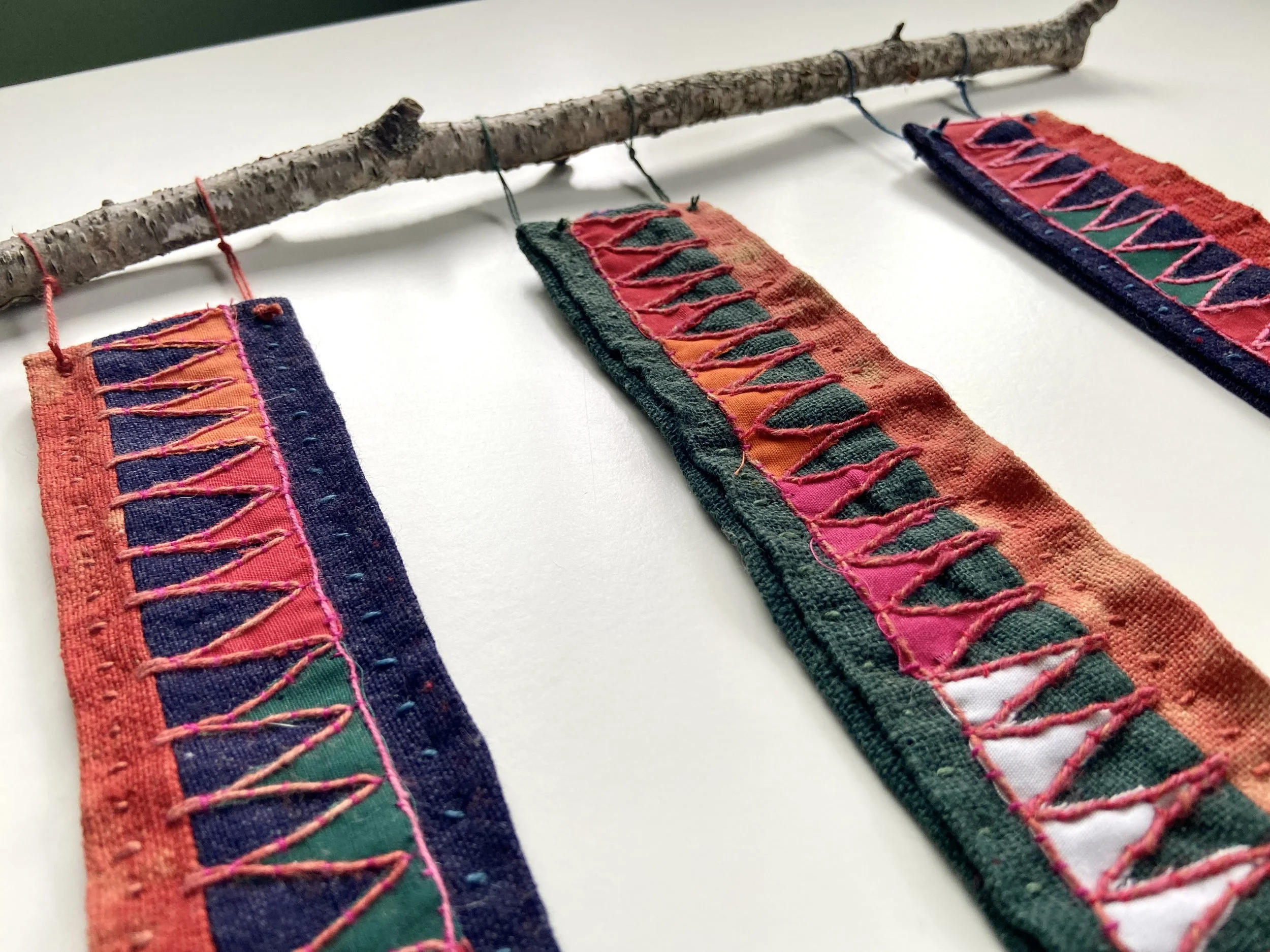 The Beauty of Sacred Reverence, mixed media fiber wall hanging made by Emma Freeman using an antique Peruvian embroidered cloth, slow hand stitching, hand embroidery and a gathered birch branch from my yard in Wisconsin. My art practice is my spiritu