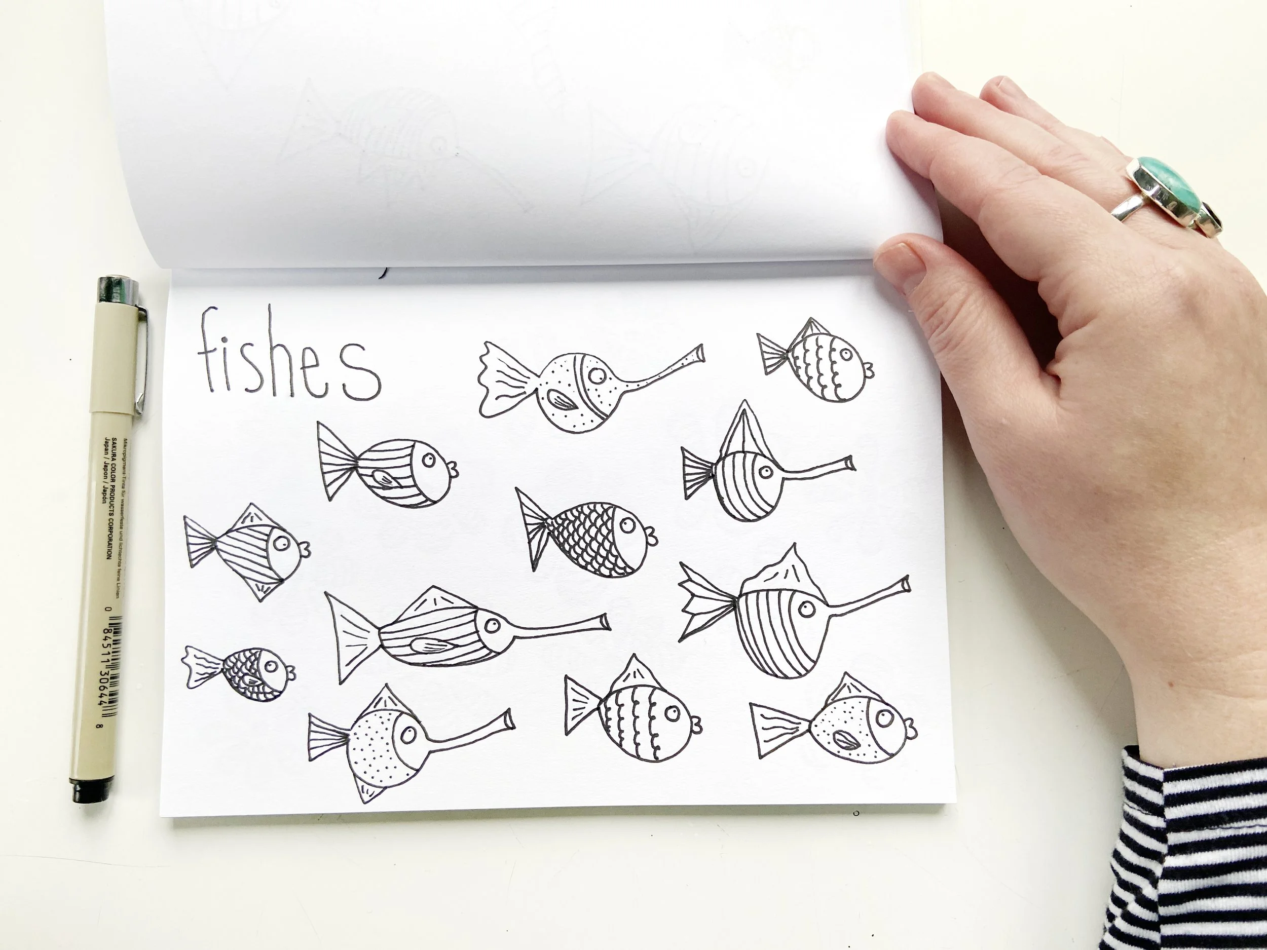 Fishes with Pen and Hand.jpeg